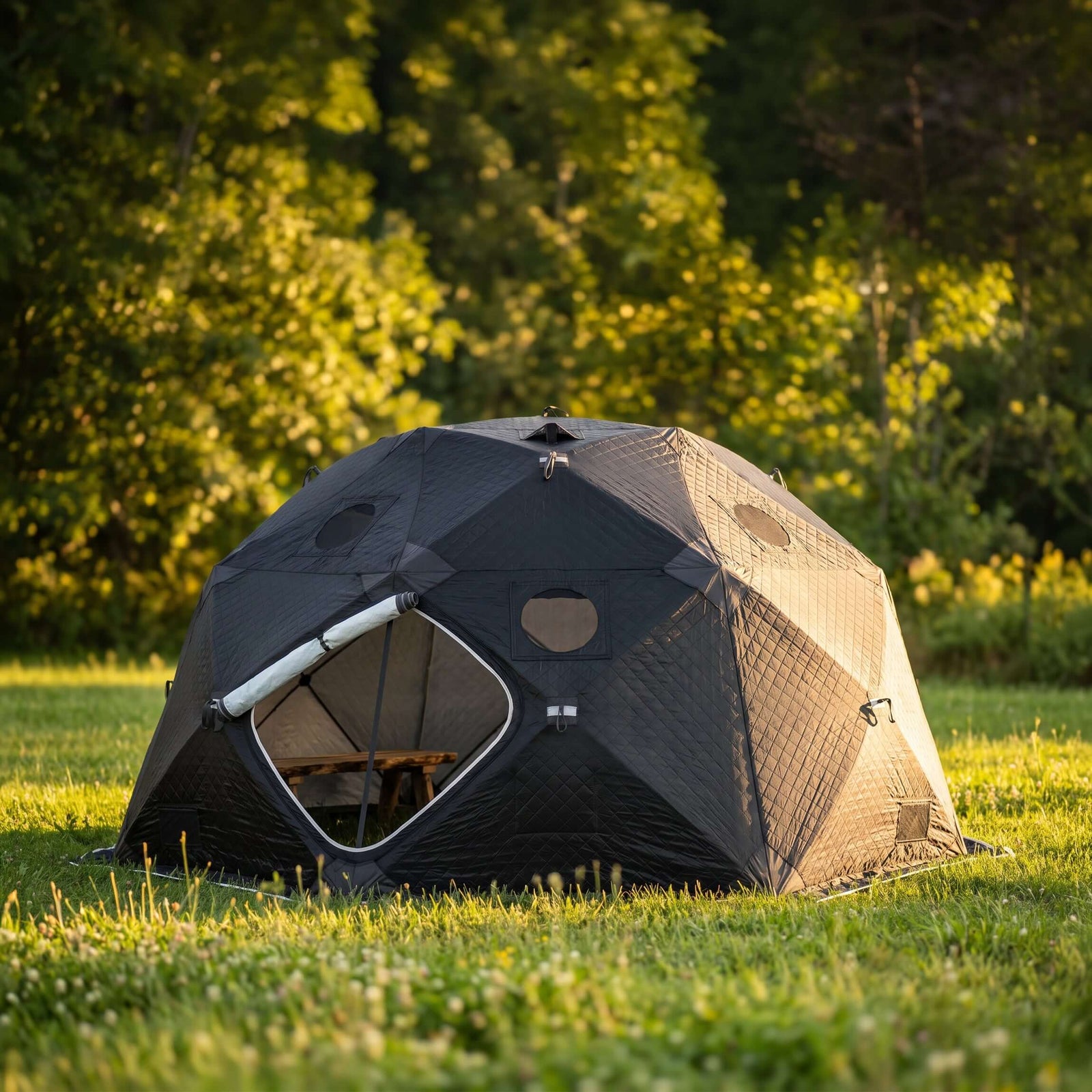SaunaLife SaunaTrekker XL Portable Sauna Tent set up in a grassy area with trees in the background, spacious for up to 6 bathers.
