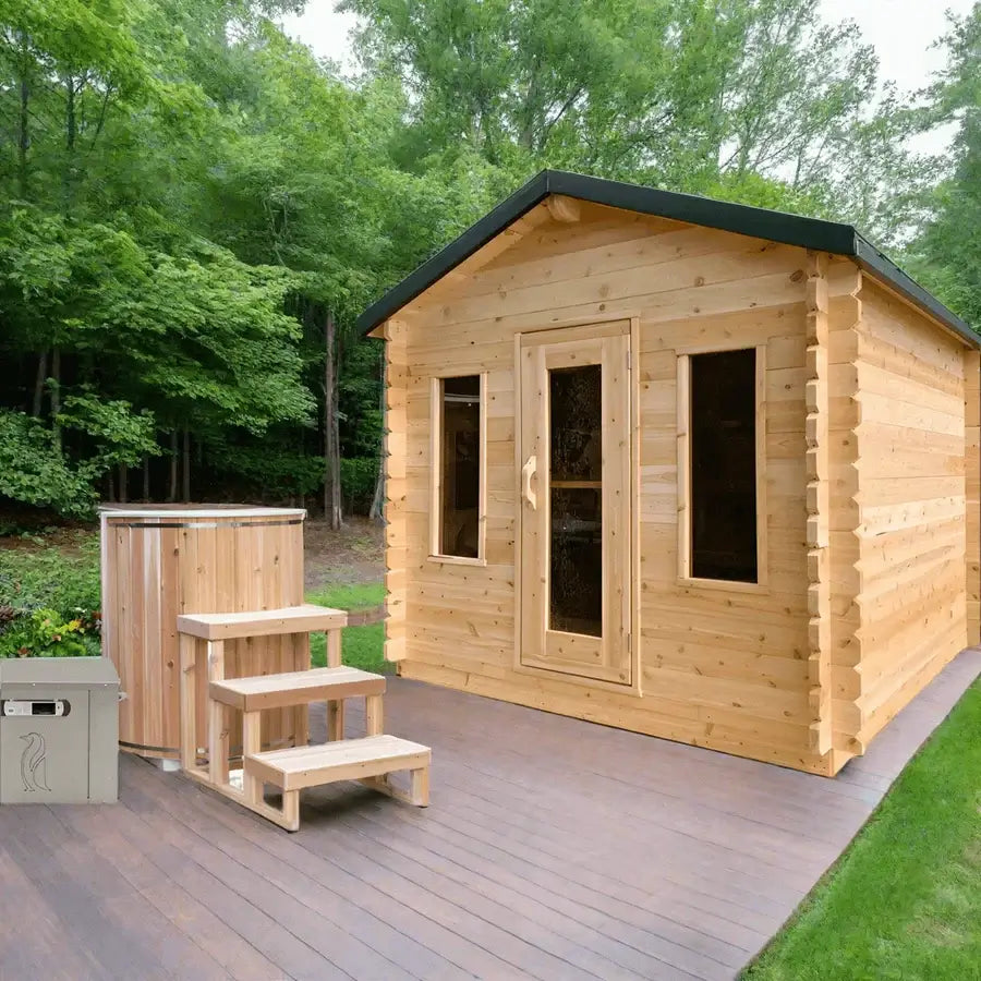 Dundalk Leisurecraft Georgian cabin sauna in a lush outdoor setting with steps and a hot tub.