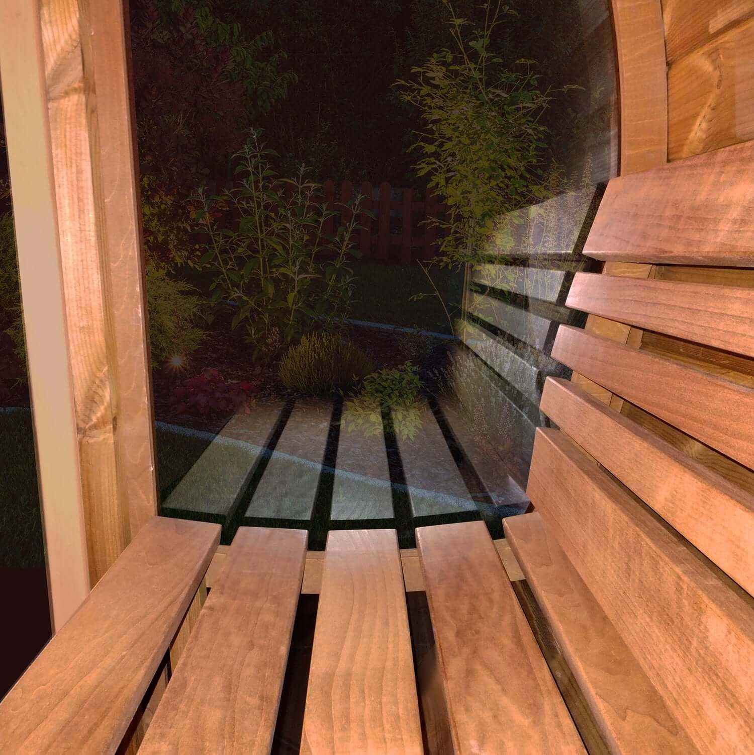 Close-up on SaunaLife ergonomic wooden bench and backrest, with a glass wall and an outside view on trees at night.