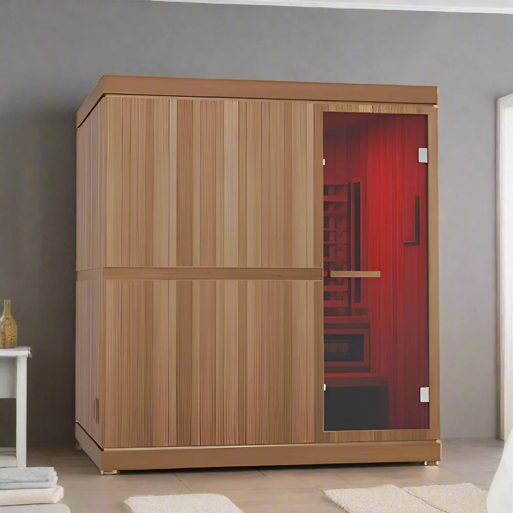 Finnmark Designs FD-5 wooden sauna room with a glass door, shown in a modern interior setting with gray walls and light flooring, red-light is visible inside the sauna indicating chromotherapy lighting