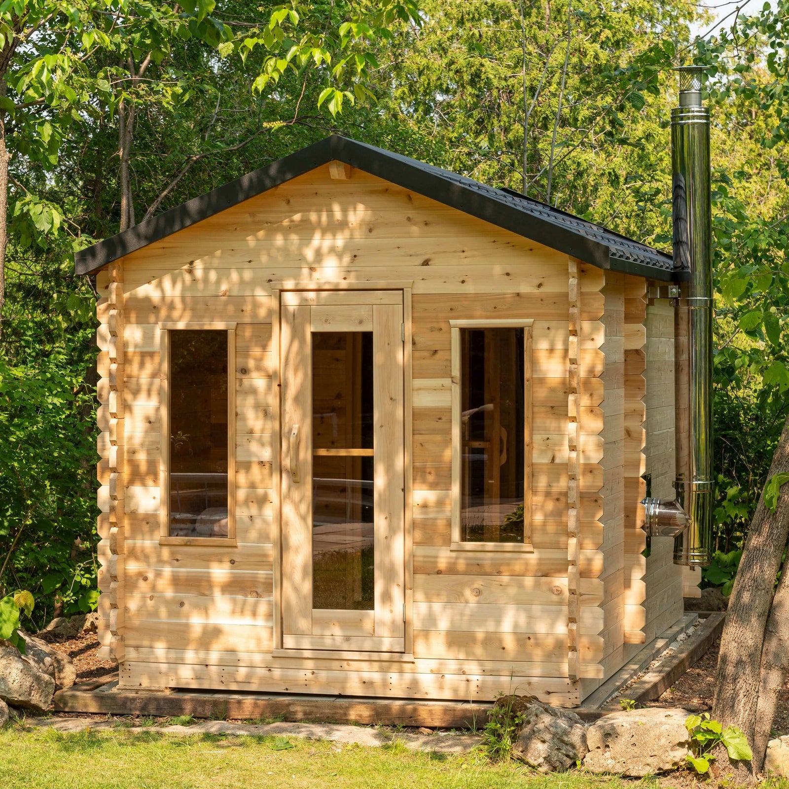 Dundalk Leisurecraft Georgian Cabin Sauna with Changeroom made from sustainable white cedar, featuring changeroom, in serene outdoor setting. CTC88CW