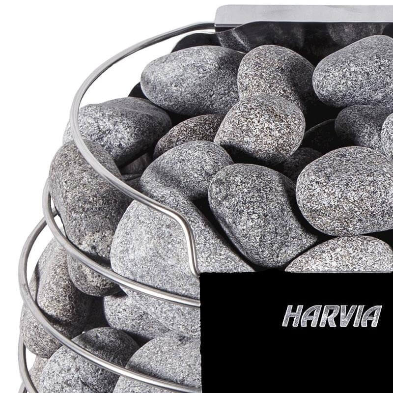 Close-up of the Harvia Spirit electric sauna heater, it's sauna basket filled with gray stones with 'Harvia' branding