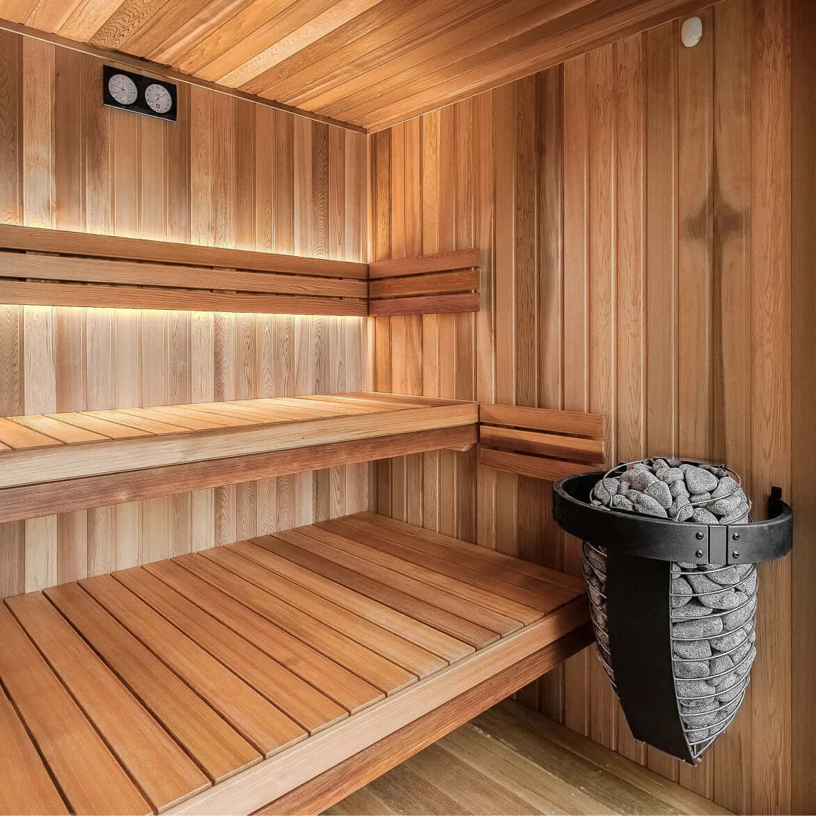 Wooden sauna with benches and the Harvia Spirit electric sauna heater full of stones
