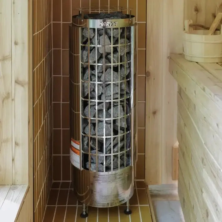 Harvia Cilindro Half Series pillar heater stove with visible stones in a tiled sauna room
