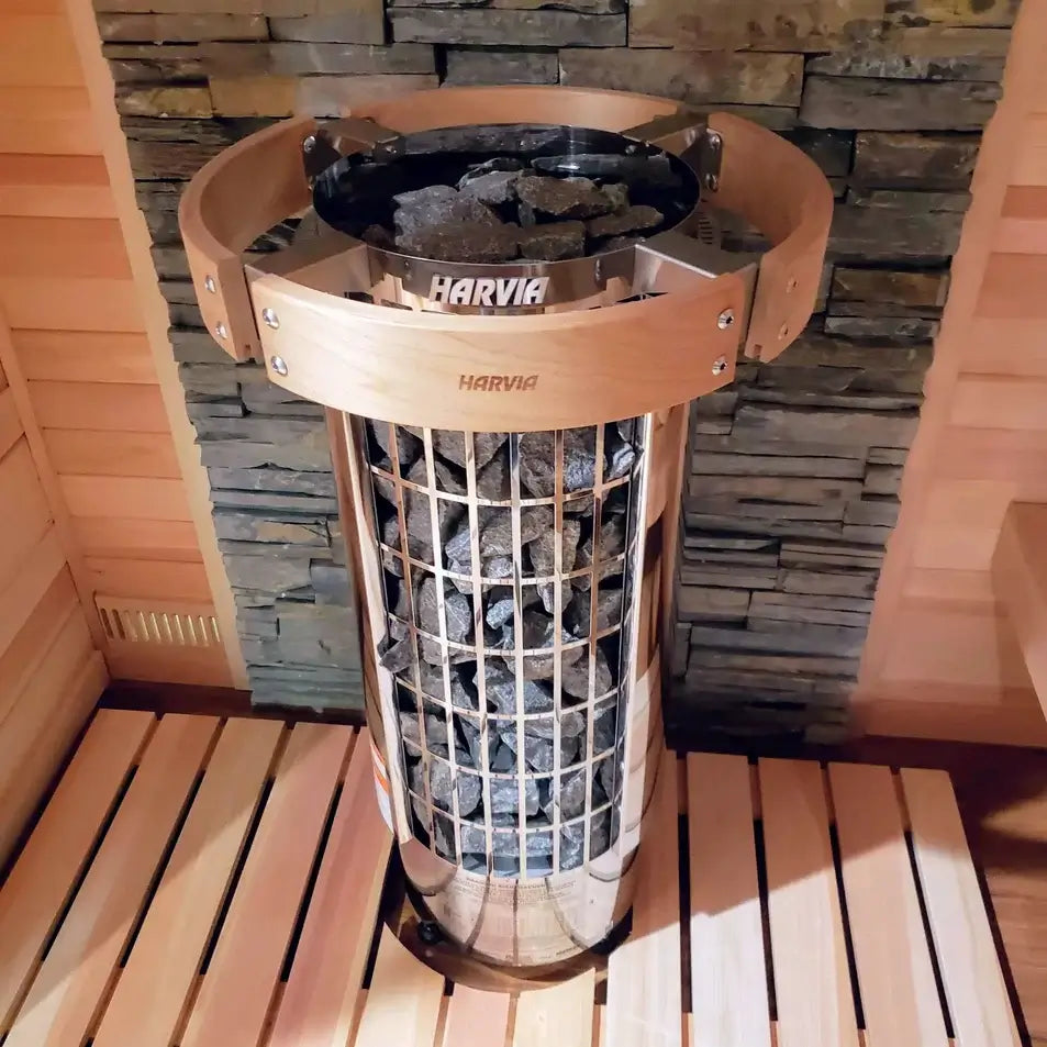 Harvia Cilindro half series electric sauna heater with exposed stone pillar in a wooden sauna setting