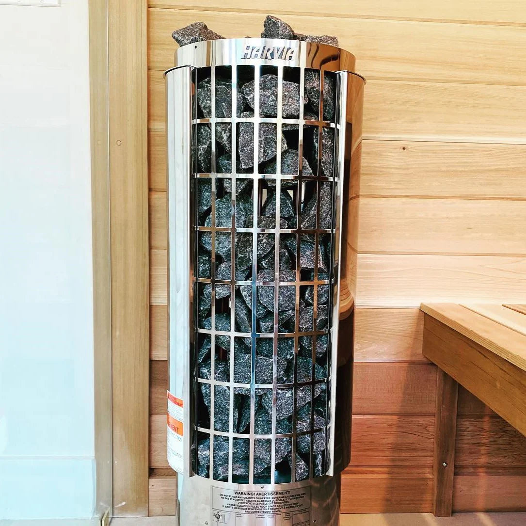 Harvia Cilindro Half electric sauna heater with stones inside a wooden sauna room