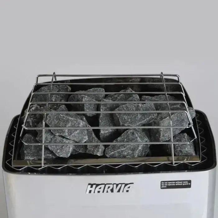 Harvia KIP sauna heater with rocks on a gray background.