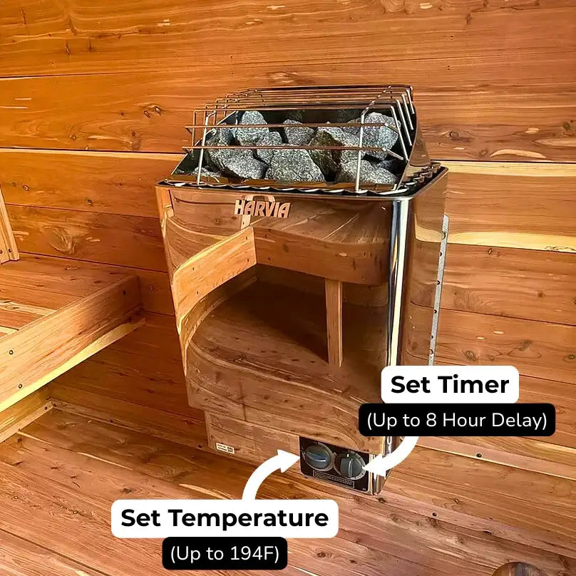 Wooden sauna with Harvia KIP with built in controls sauna heater with metal basket, rocks, and controls for setting temperature and timer.