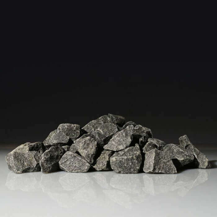 Pile of Harvia gray stones on a reflective surface with a black background