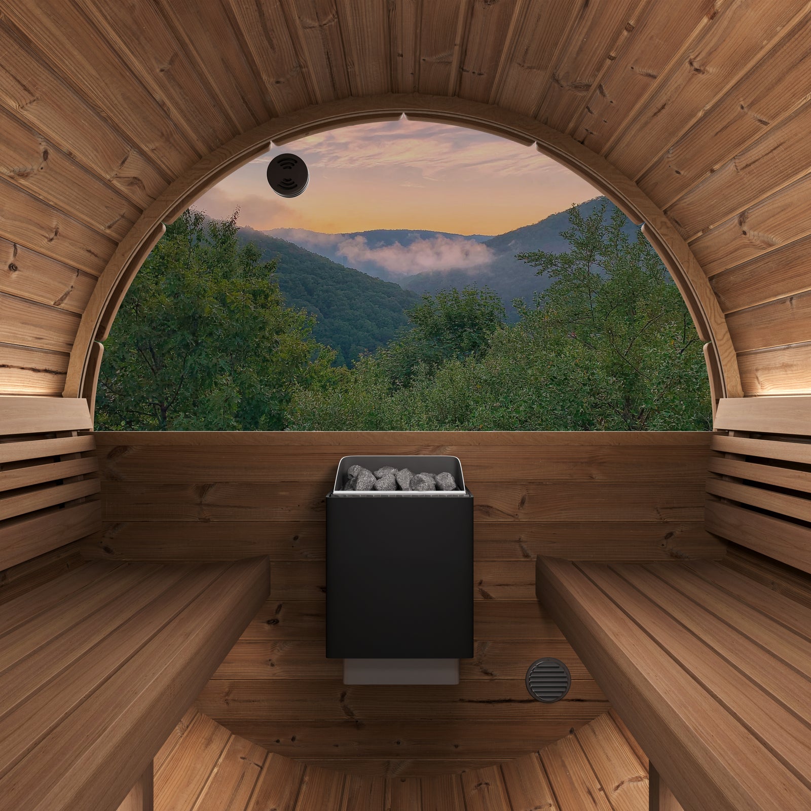 SaunaLife E8W modern wooden sauna interior with two wooden benches, black Harvia KIP sauna stove in the center, and a large panoramic half-moon rear window overlooking a mountain forest landscape at sunset.