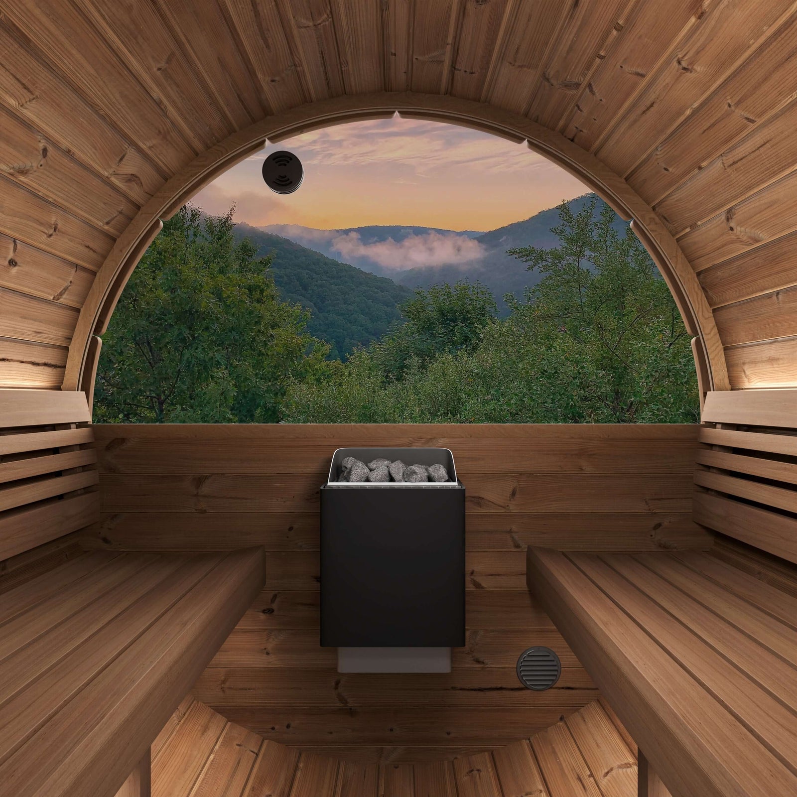 SaunaLife E8W modern wooden sauna interior with two wooden benches, black Harvia KIP sauna stove in the center, and a large panoramic half-moon rear window overlooking a mountain forest landscape at sunset.