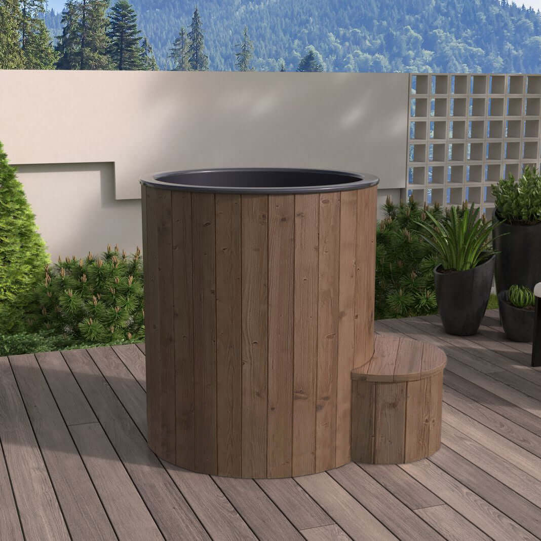 Wooden S1N immersion tub on a wooden deck with plants and forest in the background