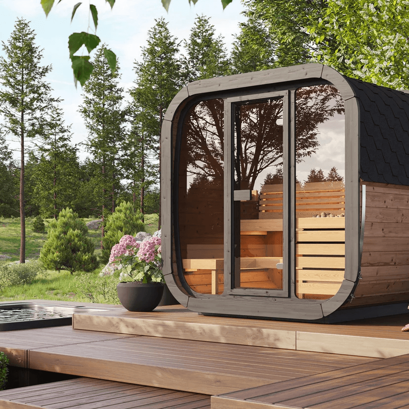SaunaLife CL5G outdoor 4-person cube sauna kit surrounded by nature and greenery.