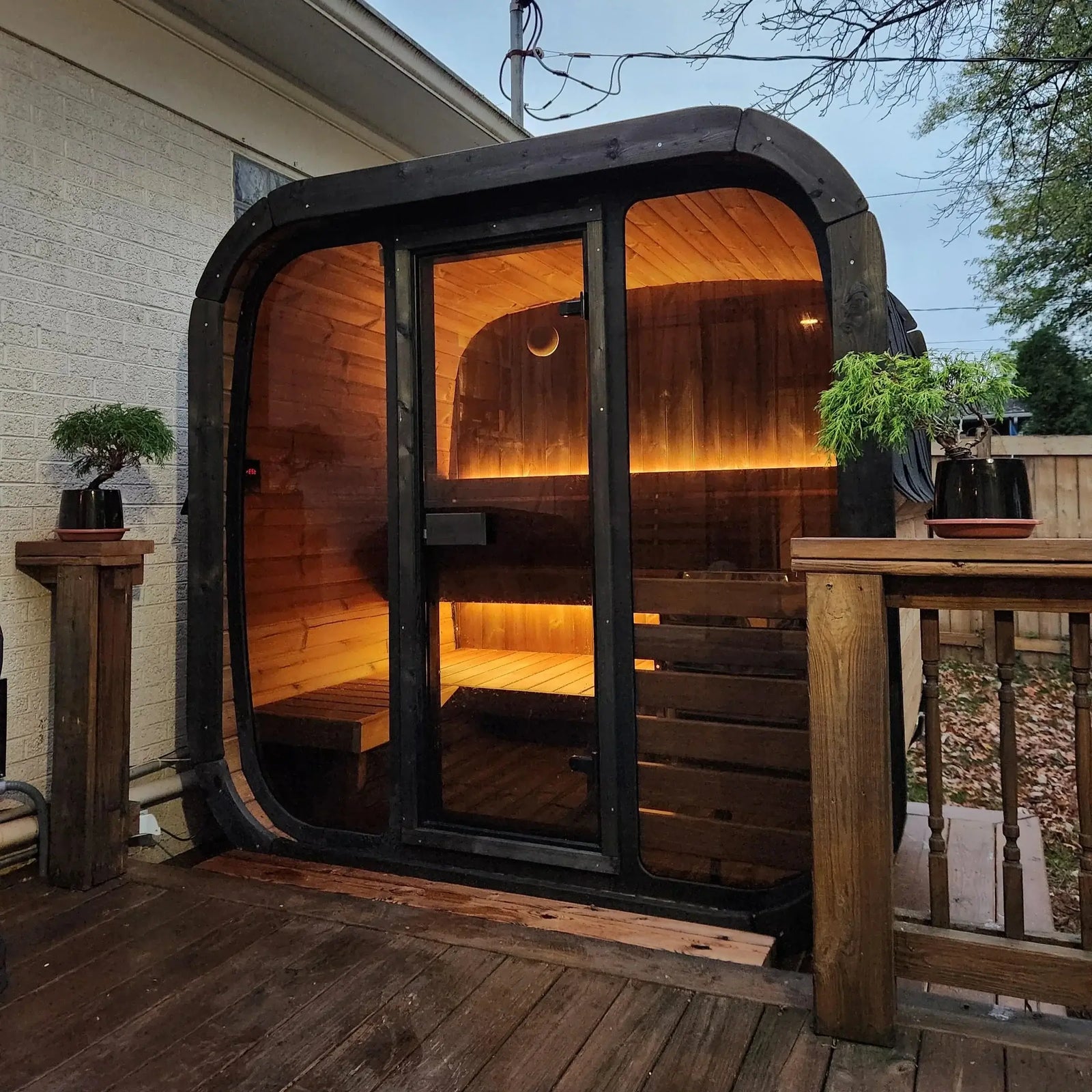 SaunaLife CL5G: Stylish outdoor cube sauna kit with glass door and warm interior lighting, perfect for relaxation.