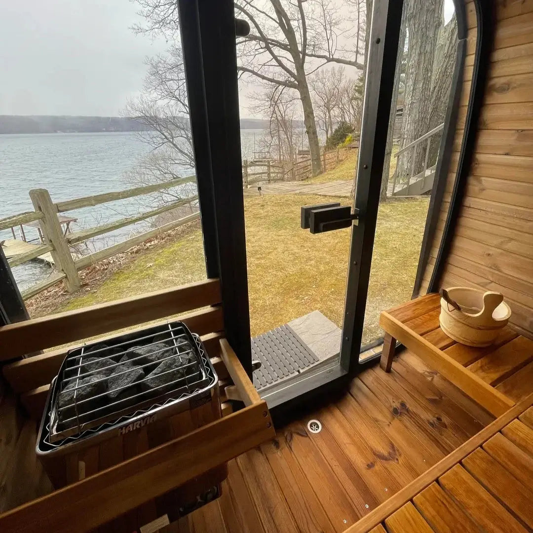 Interior view of the SaunaLife CL5G showcasing natural wood seating and a scenic lake view.