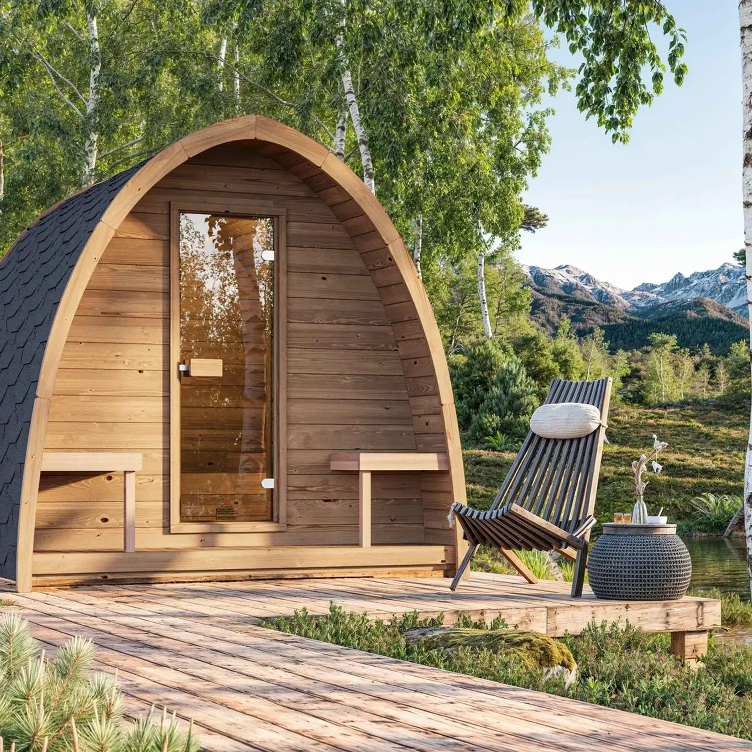 Wooden SaunaLife G3 sauna pod with a chair and plant in a natural setting with mountains and trees.