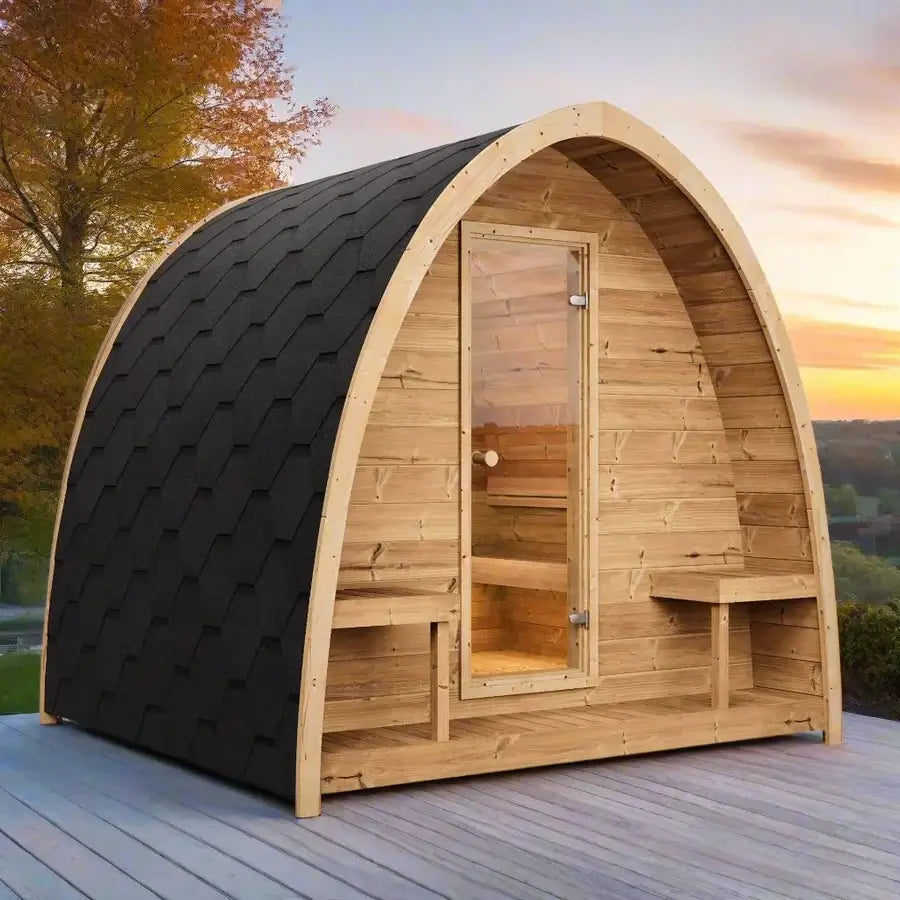 SaunaLife's G3, a wooden outdoor sauna with black roof on a wooden deck during sunset.