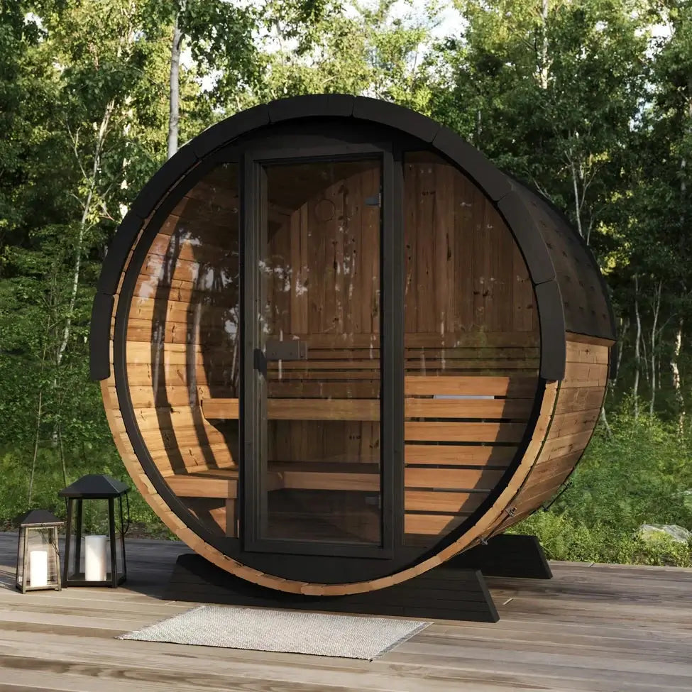 SaunaLife EE6G sauna, a four-person barrel-shaped sauna from SaunaLife, featuring a full glass facade and a wooden barrel structure, with an arched backrest and contoured bench for ergonomic comfort, in a forest setting