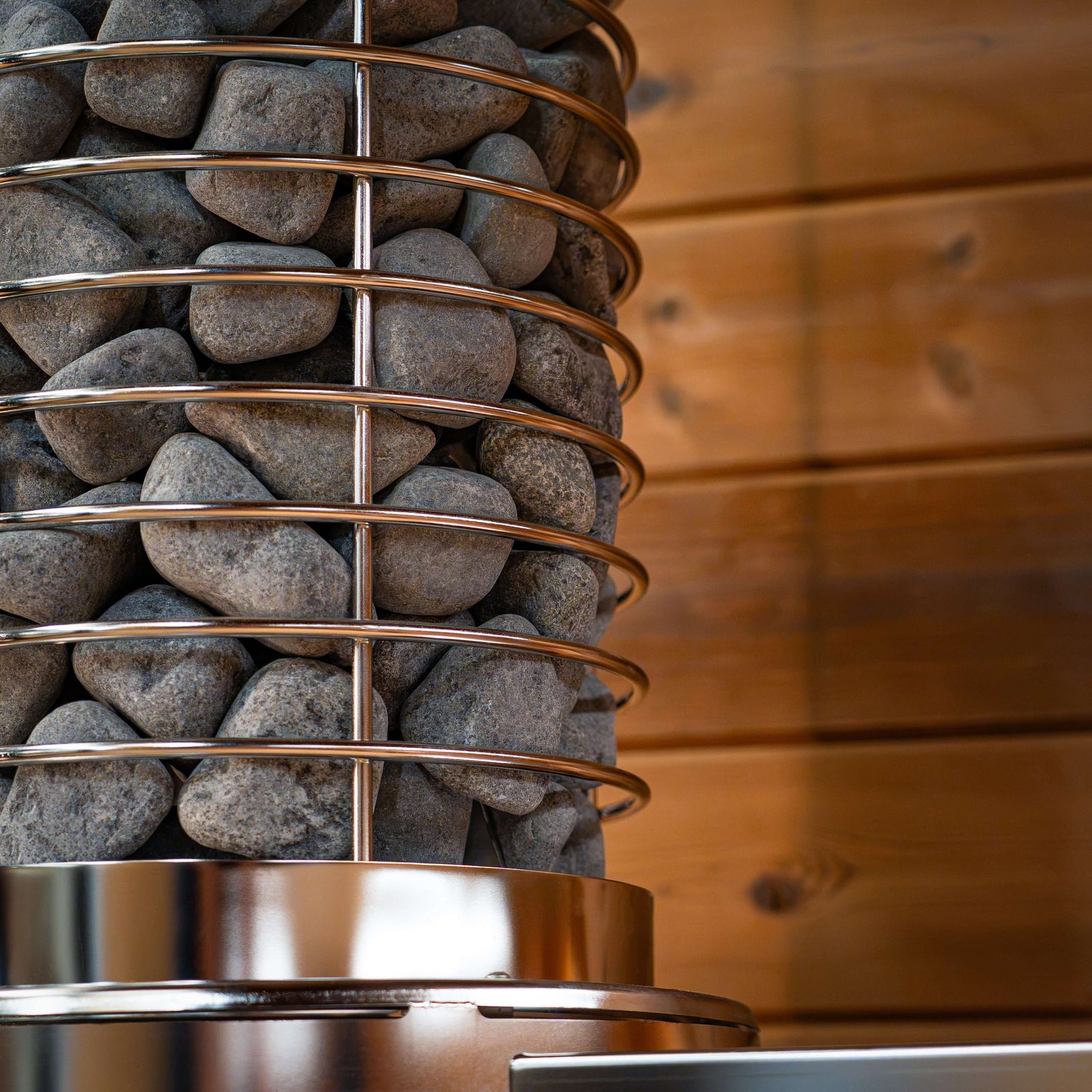 SaunaLife TITAN SL1 Portable Propane Sauna Heater with stones in a sleek design for optimal sauna experience.