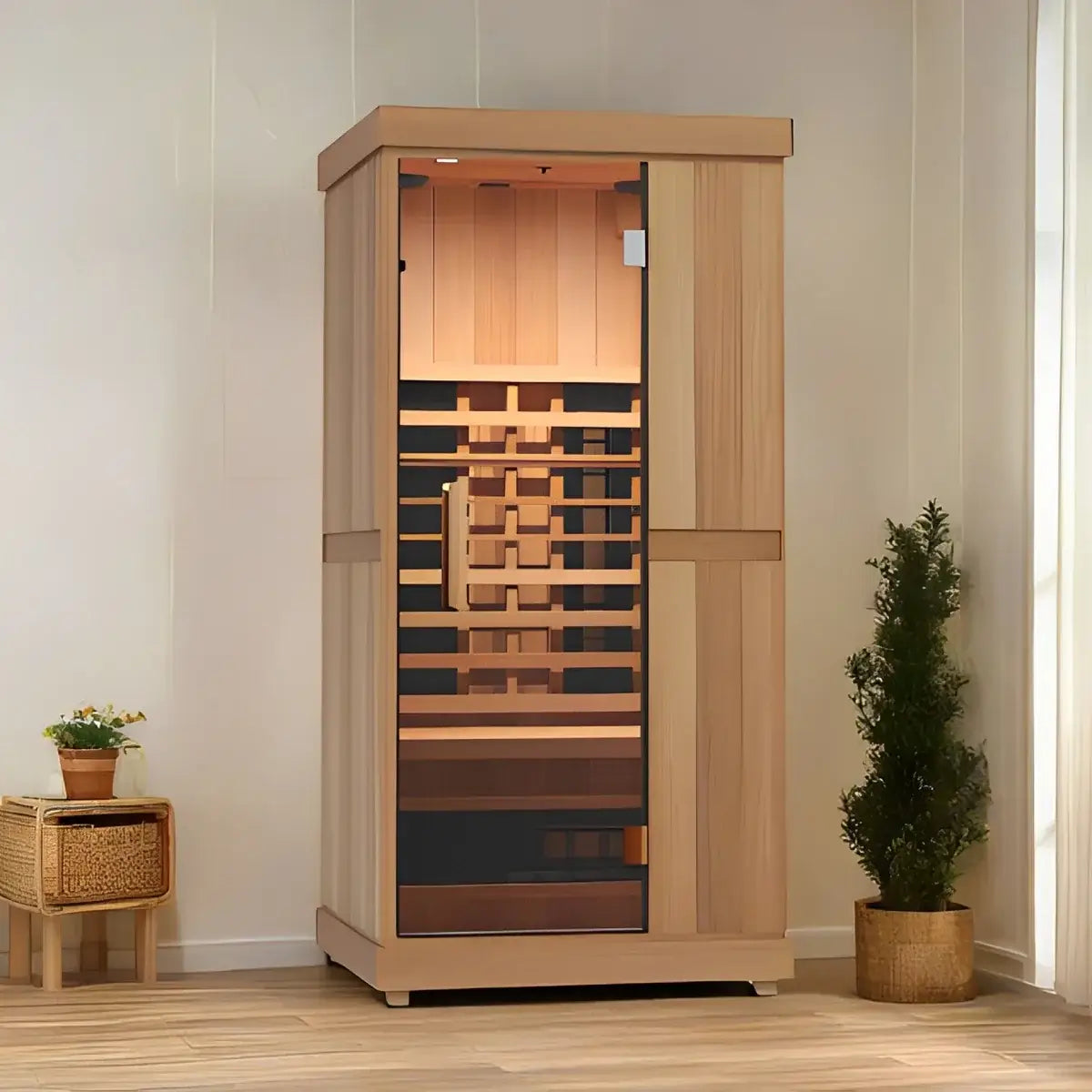 Wooden Finnmark FD-1 1-person full spectrum infrared sauna in a room with plants and a side table.