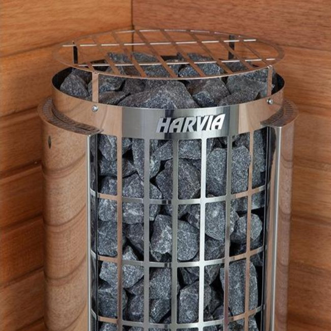 Harvia Cilindro sauna heater with rocks, inside a wooden sauna.