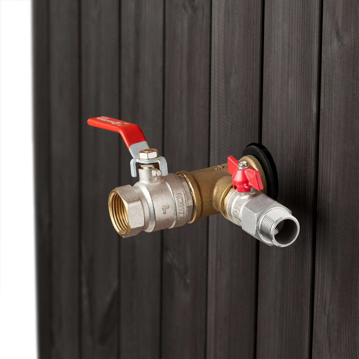 Close-up of the brass valve with red handles attached to the black wooden SaunaLife S2B immersion tub 