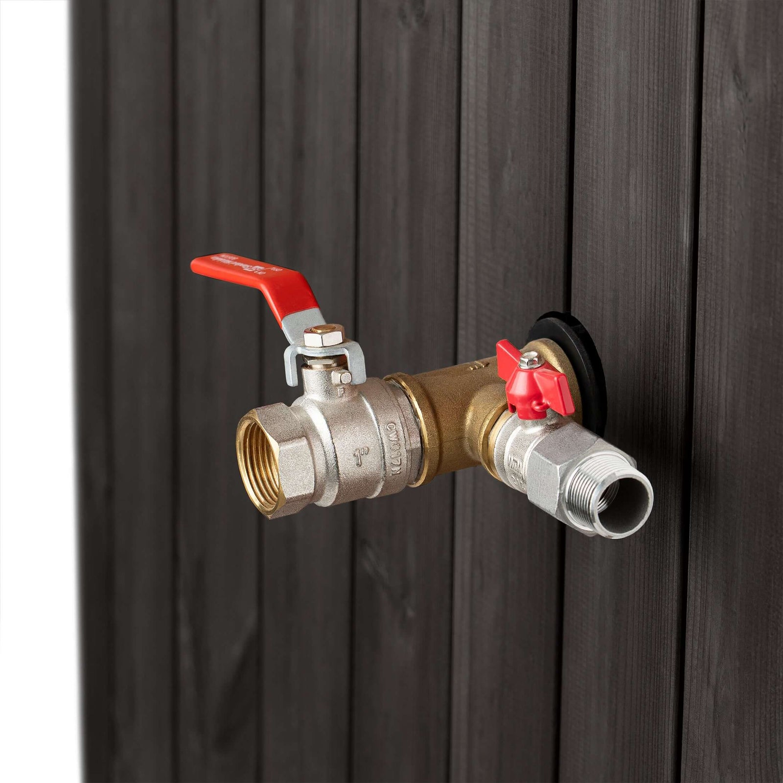 Close-up of the brass valve with red handles attached to the black wooden SaunaLife S2B immersion tub 