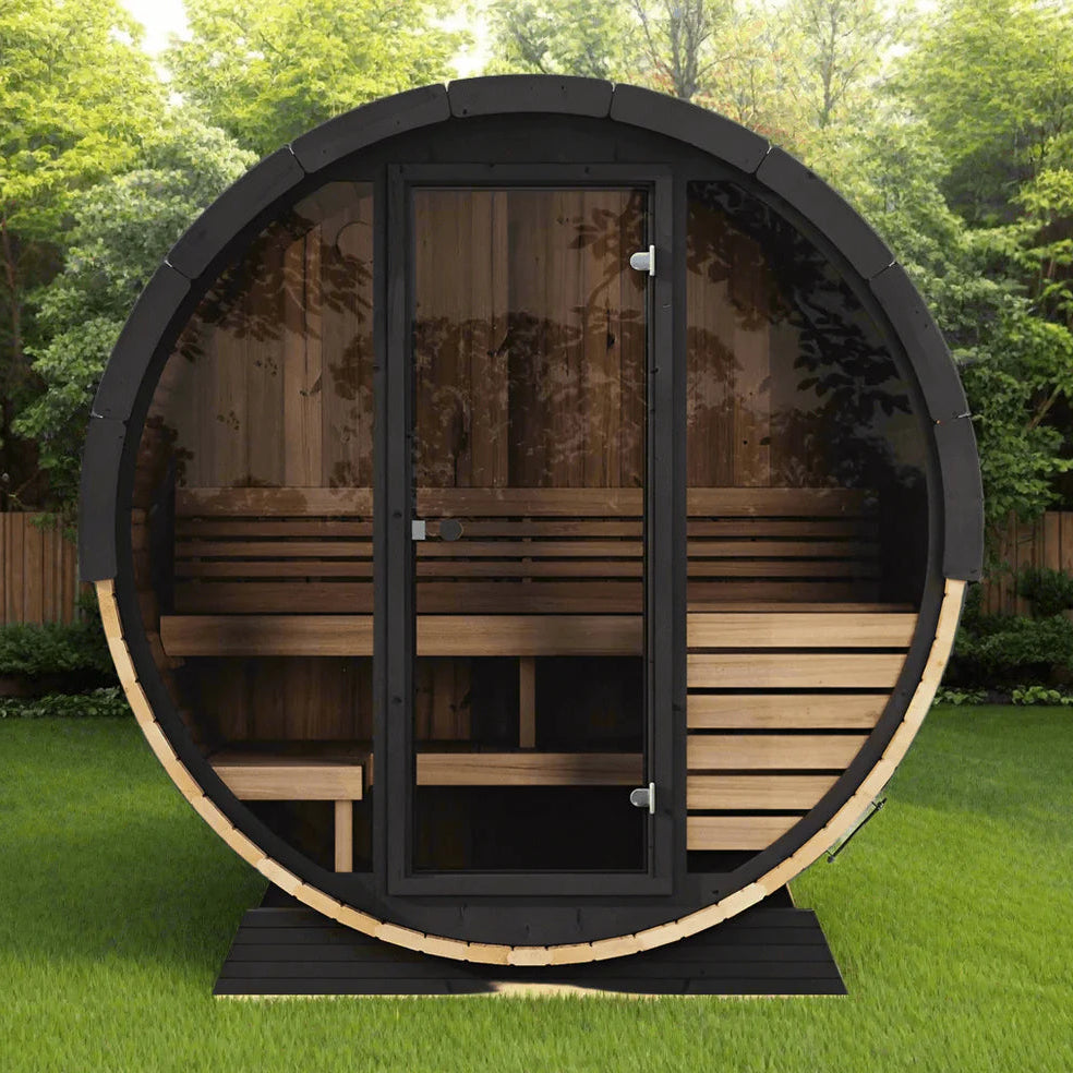 Wooden outdoor sauna with glass doors on a grassy area with trees in the background
