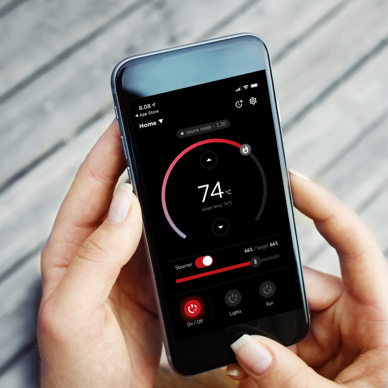 Person holding a smartphone with the myharvia control application displayed on the screen.