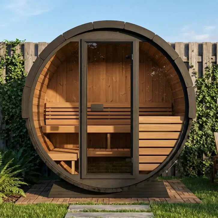 SaunaLife EE6GB, a round wooden sauna cabin with glass door and glass front wall and built-in wooden seating, placed outdoors in a garden setting with a wooden fence and plants.
