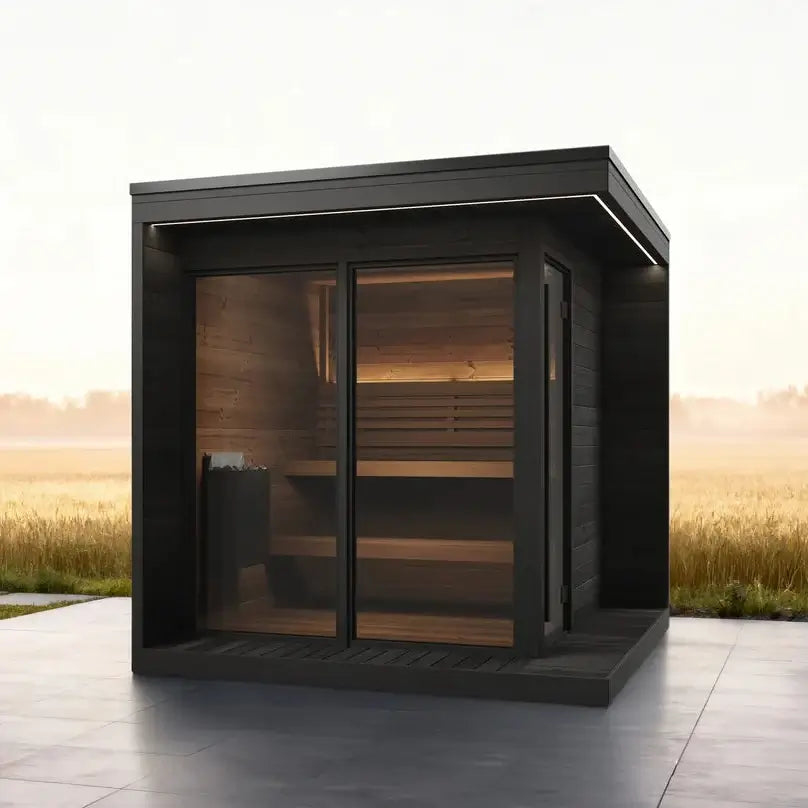 SaunaLife's GL6B modern outdoor sauna cabin with dark wood framing, a large glass door and windows, situated on a tiled patio, overlooking a misty field at sunrise.