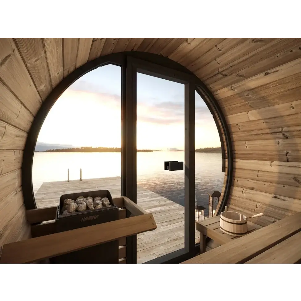 Interior of SaunaLife's EE6G wooden sauna with large window overlooking a dock and water at sunset.