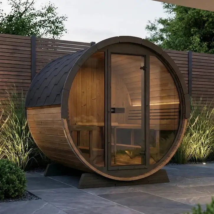 SaunaLife EE8G wooden barrel-shaped sauna in a garden setting with plants and a wooden fence.
