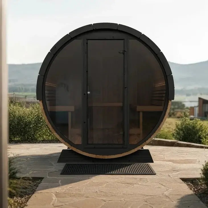 Wooden barrel-shaped SaunaLife EE8G sauna on a patio with scenic background