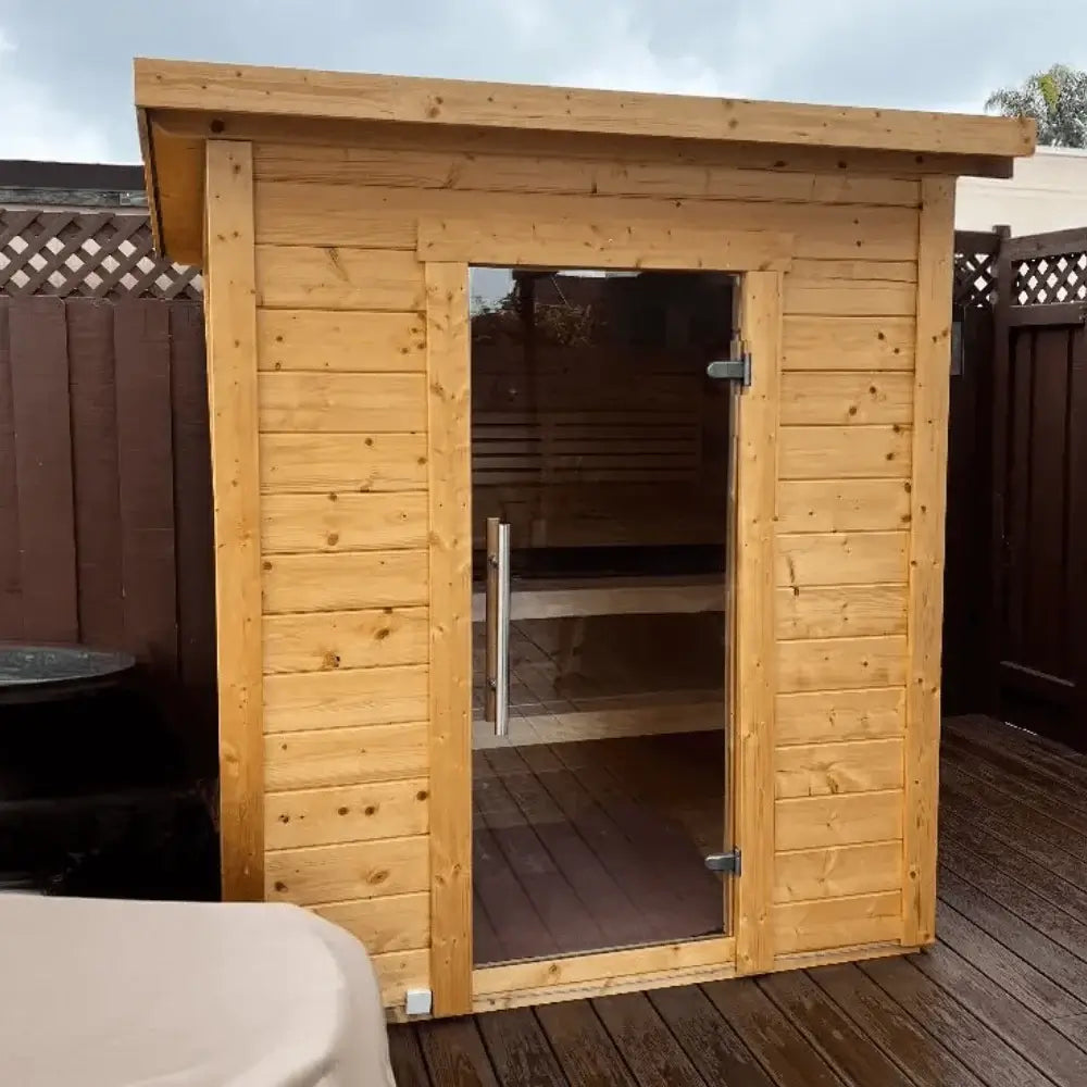 SaunaLife G2 wooden sauna with glass door on a wooden deck